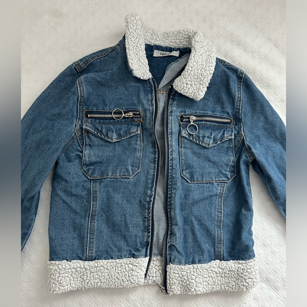 small refuge blue jeans jacket, with white fluff on top and bottom, with zipper